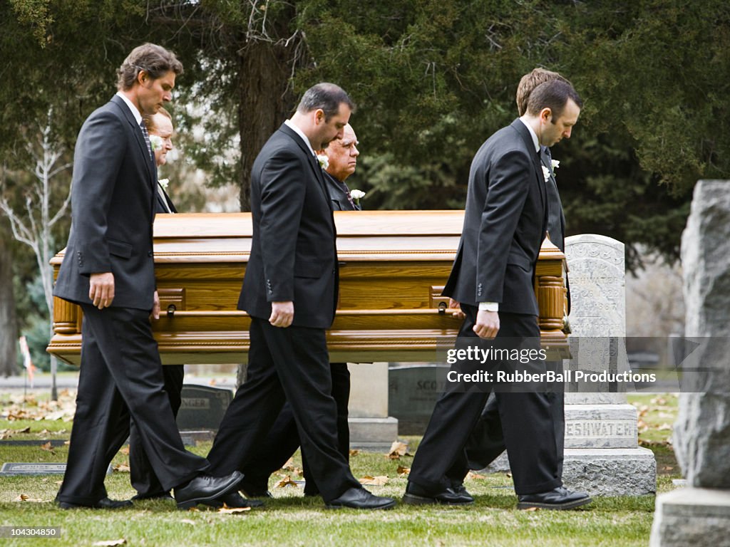 People at a funeral in a cemetery