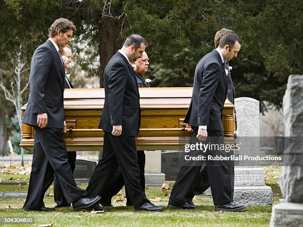 people at a funeral in a cemetery - pallbearer fotografías e imágenes de stock