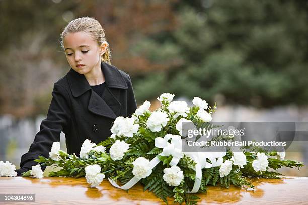 girl at a funeral standing next to a coffin - martin mcguinness is mourned ahead of his funeral stockfoto's en -beelden