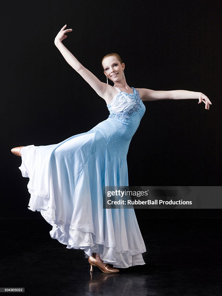 Young woman in dress dancing