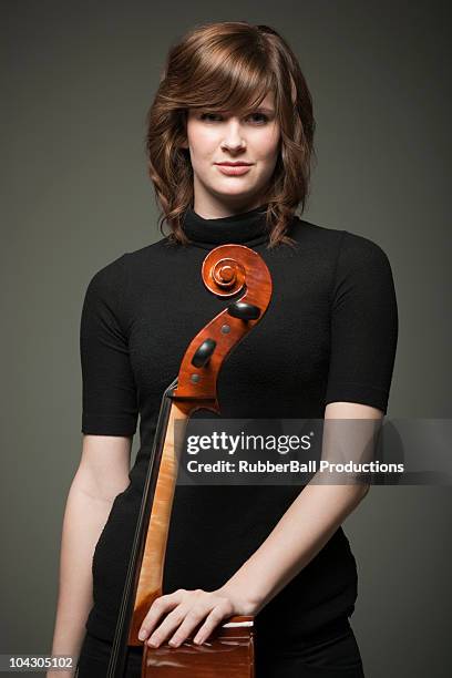 studio portrait of young woman with cello - portrait of a musician stock pictures, royalty-free photos & images