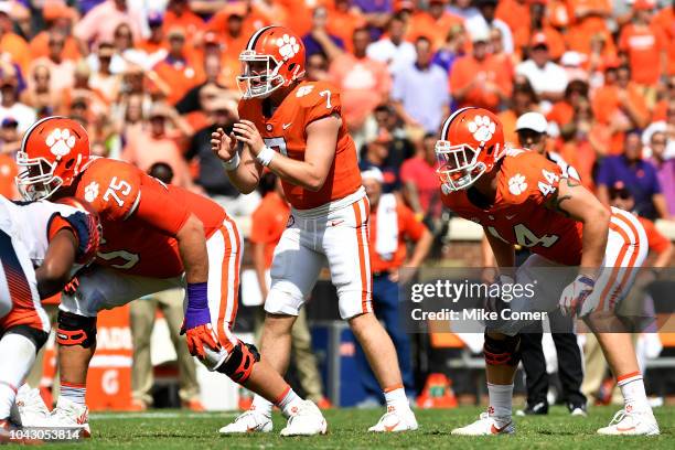 Quarterback Chase Brice prepares for the snap as offensive tackle Mitch Hyatt and tight end Garrett Williams of the Clemson Tigers line up against...