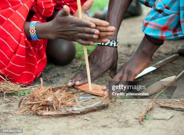 maasai making fire, masai mara, kenya, africa - bracelet making stock pictures, royalty-free photos & images