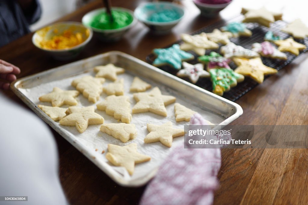 Woman carrying a tray of Christmas cookies