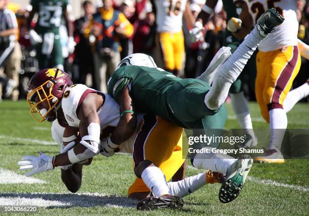 Julian Hicks of the Central Michigan Chippewas catches a second half touchdown next to Justin Layne of the Michigan State Spartans at Spartan Stadium...