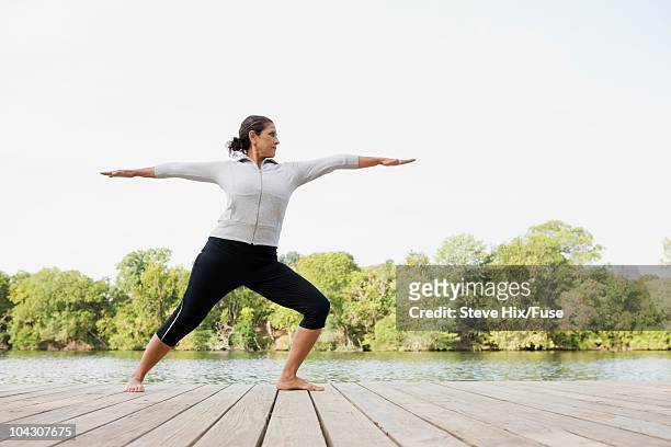 woman practicing yoga - full figure stock pictures, royalty-free photos & images