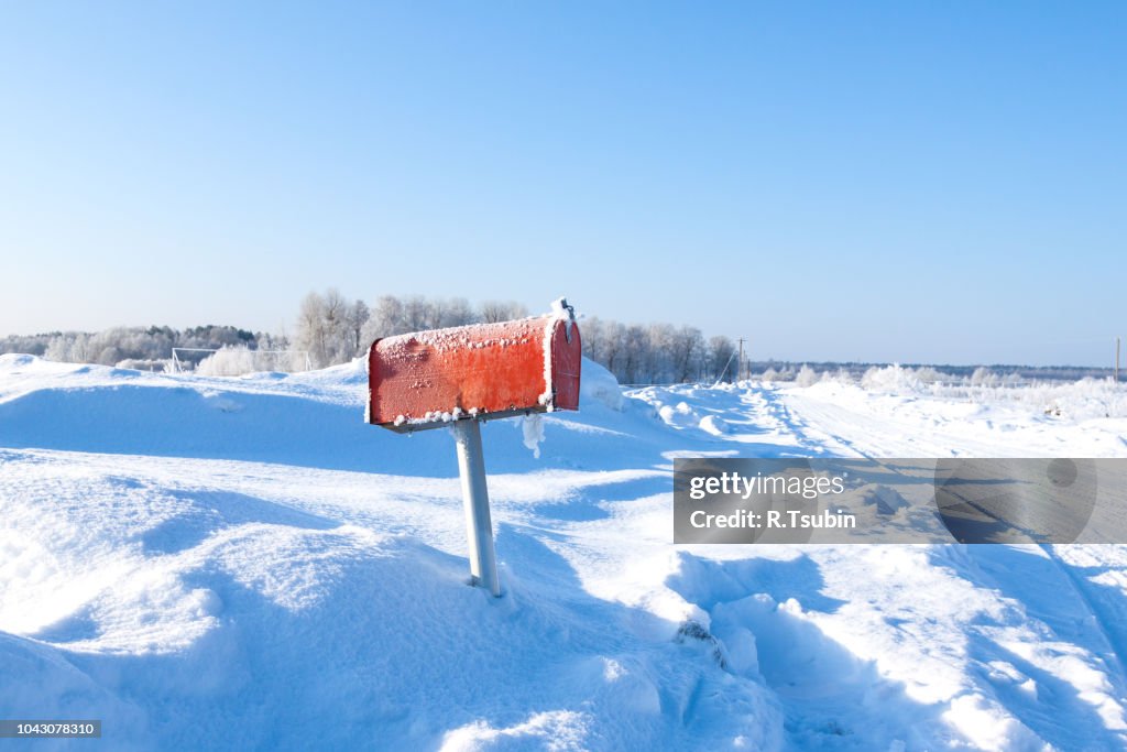Winter frozen mail box under snow