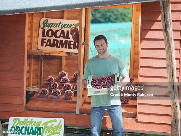 farmer showing box full of cherries - fruit carton stock pictures, royalty-free photos & images