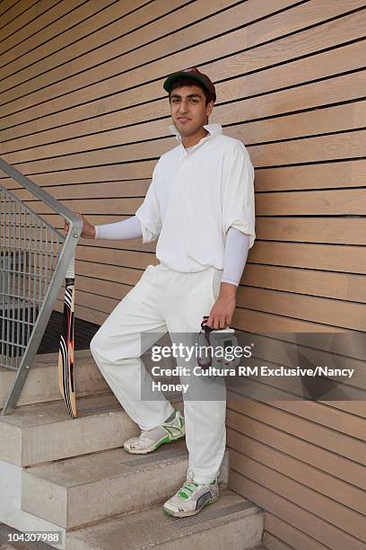 young asian man in his cricket kit - cricket player portrait stock pictures, royalty-free photos & images