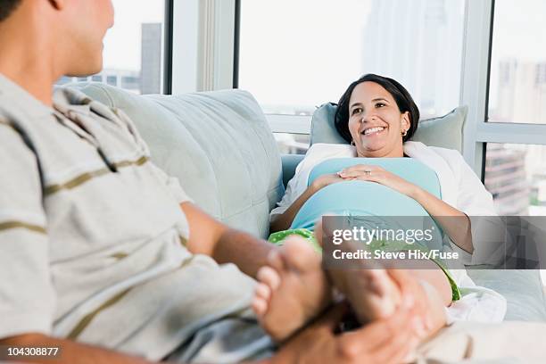 man massaging a woman's feet - husband and wife massage stock-fotos und bilder