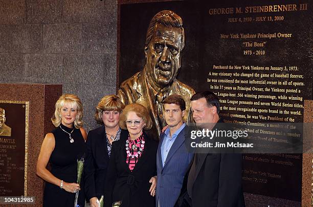 The family of late New York Yankees owner George Steinbrenner poses in front of the newly unveiled monument prior to game against the Tampa Bay Rays...