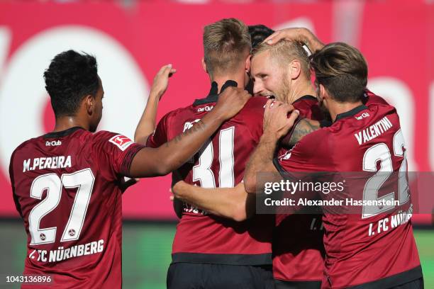 Hanno Behrens of Nuernberg celebartes scoring the opening goal with his team mates during the Bundesliga match between 1. FC Nuernberg and Fortuna...