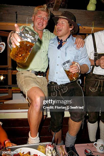 Stefan Effenberg and Larry Izzo of the New England Patriot attend the third evening of the Oktoberfest 2010 at Kaefers Wiesnschaenke at...