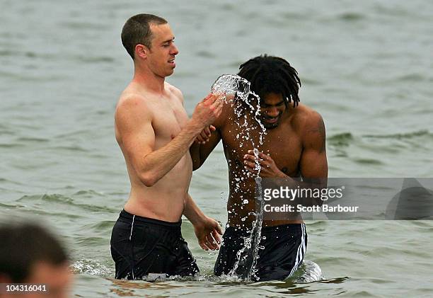 Nick Maxwell splashes Harry O'Brien of the Magpies with water during a Collingwood Magpies AFL recovery session at St Kilda Sea Baths on September...