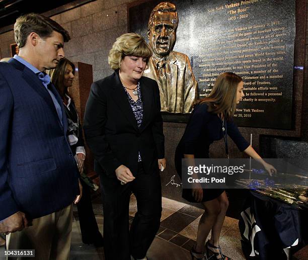 Members of the Steinbrenner family, Hal Steinbrenner, and Jessica Steinbrenner pass by their father's monument following as another member of the...