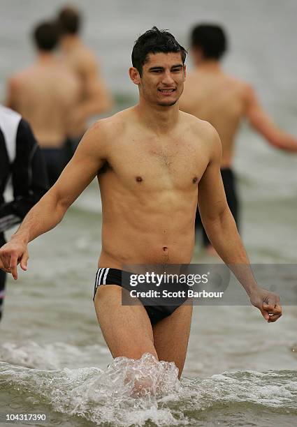 Sharrod Wellingham of the Magpies walks in the water during a Collingwood Magpies AFL recovery session at St Kilda Sea Baths on September 21, 2010 in...