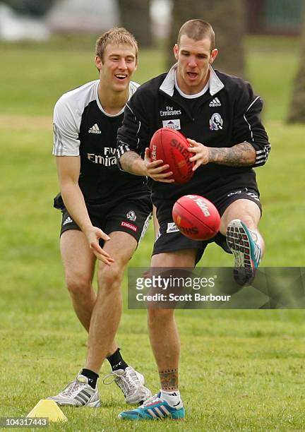 Dane Swan and Ben Reid of the Magpies take part in a training exercise during a Collingwood Magpies AFL recovery session at St Kilda Sea Baths on...