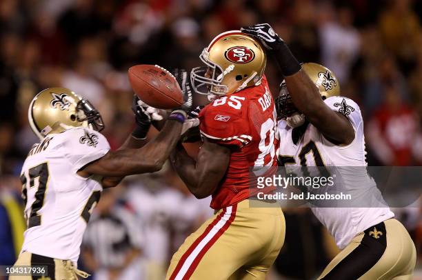 Vernon Davis of the San Francisco 49er fails to catch a pass as he is defended by Malcolm Jenkins and Marvin Mitchell of the New Orleans Saints...