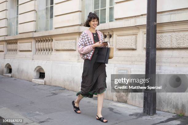 Chloe Hill is seen on the street during Paris Fashion Week SS19 wearing checker jacket on September 29, 2018 in Paris, France.