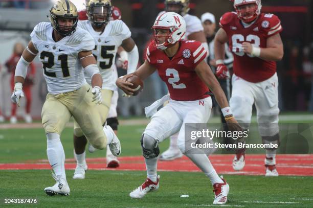 Quarterback Adrian Martinez of the Nebraska Cornhuskers runs from linebacker Markus Bailey of the Purdue Boilermakers in the second half at Memorial...