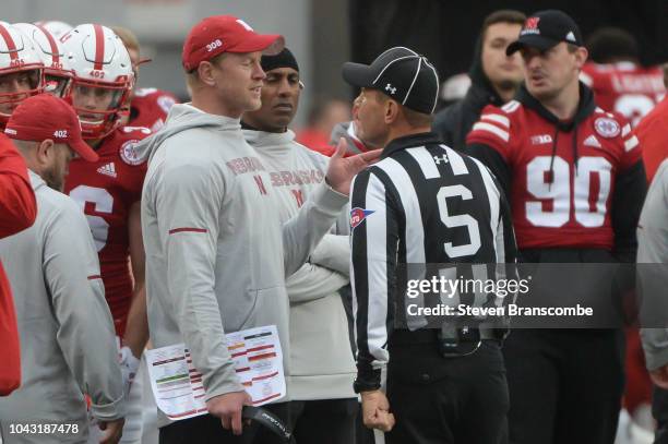 Head coach Scott Frost of the Nebraska Cornhuskers questions a call with an official in the second half of the game against the Purdue Boilermakers...