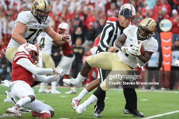 Running back D.J. Knox of the Purdue Boilermakers escapes the grip of defensive back Deontai Williams of the Nebraska Cornhuskers to score in the...