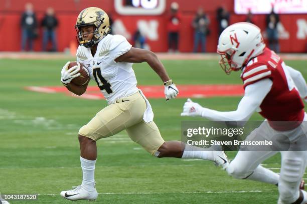 Wide receiver Rondale Moore of the Purdue Boilermakers runs from defensive back Deontai Williams of the Nebraska Cornhuskers in the first half at...