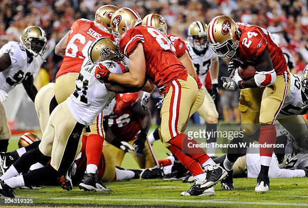 Tight End Nate Byham of the San Francisco 49ers makes the block for running back Anthony Dixon to score a touchdown against the New Orleans Saints...