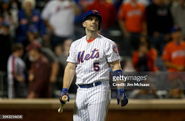 David Wright of the New York Mets walks back to the dugout after fouling out during the fourth inning against the Miami Marlins at Citi Field on...