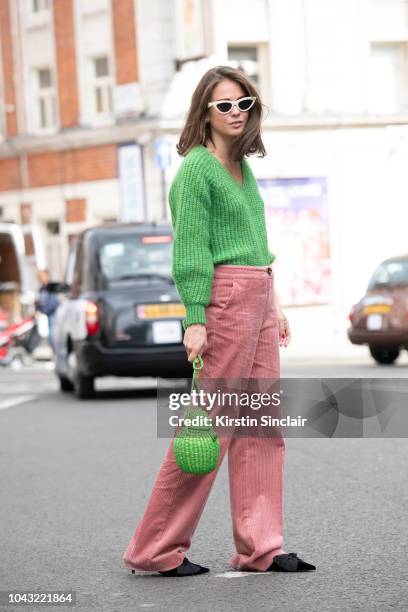 Pr consultant Therese Hellstrom wears Stureoptikern sunglasses and a Pitusa bag during London Fashion Week September 2018 on September 14, 2018 in...