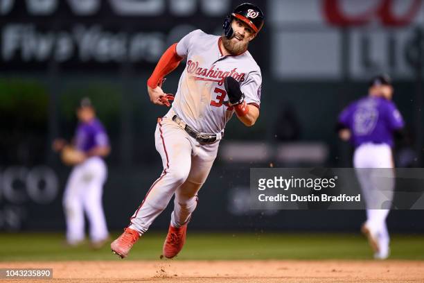 Bryce Harper of the Washington Nationals advances from first to third in the ninth inning of a game against the Colorado Rockies at Coors Field on...