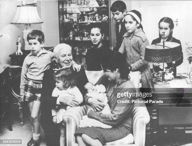 Comic actor Charlie Chaplin with his wife Oona O'Neill and their children, including newborn Annette, at their home, the Manoir de Ban, Switzerland,...