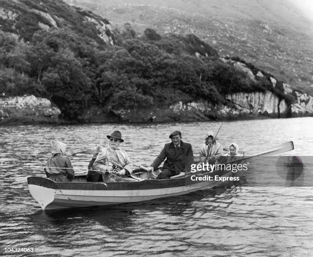 Comic actor Charlie Chaplin and family on a fishing holiday in Killarney, Ireland, 14th July 1960. Chaplin's wife Oona O'Neill is on the far right.
