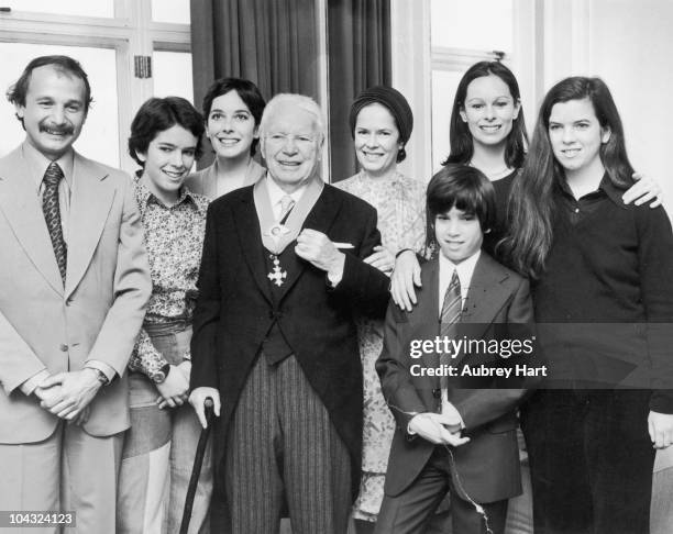 Comic actor Charlie Chaplin with his wife Oona O'Neill and family at the Savoy Hotel, London after Chaplin received his knighthood at Buckingham...