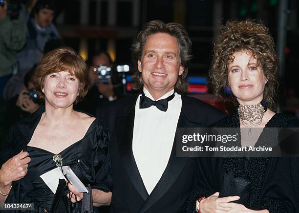 American actor Michael Douglas attending the UK premiere of Oliver Stone's film 'Wall Street' with his wife Diandra, right, and another guest, London...