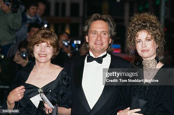 American actor Michael Douglas attending the UK premiere of Oliver Stone's film 'Wall Street' with his wife Diandra, right, and another guest, London...
