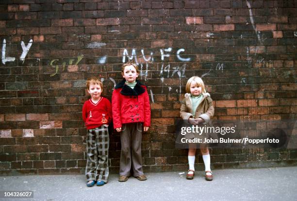 Three children on a street in Manchester, England in 1976.