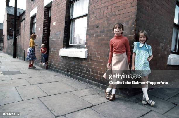 Little girls on a street corner in Manchester, England in 1976.