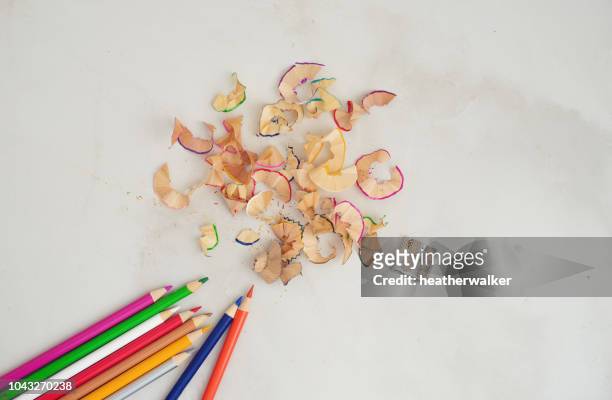 colored pencils and pencil shavings - pencil shavings stock pictures, royalty-free photos & images