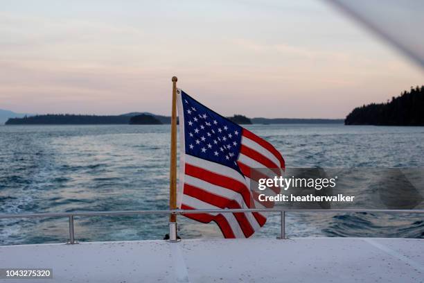 american flag on the back of a boat, san juan islands, washington, united states - american flag ocean stock pictures, royalty-free photos & images