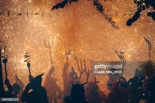 silhouette of people at the correfoc festival, catalonia, spain - correfoc stockfoto's en -beelden