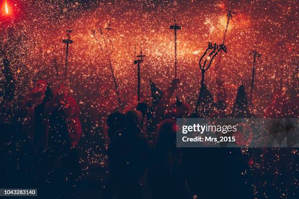 silhouette of people at the correfoc festival, catalonia, spain - disfraz de diablo fotografías e imágenes de stock