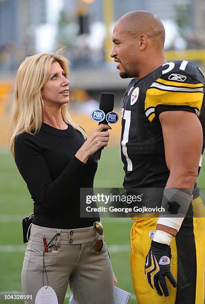 Fox Sports National Football League sideline reporter Laura Okmin interviews linebacker James Farrior of the Pittsburgh Steelers after a game against...
