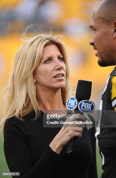 Fox Sports National Football League sideline reporter Laura Okmin interviews linebacker James Farrior of the Pittsburgh Steelers after a game against...
