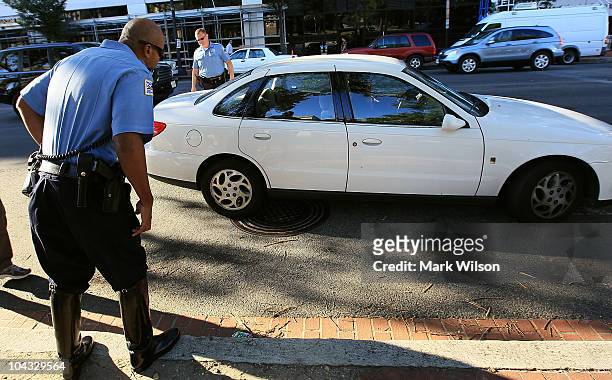 Metropolitan Police Officer Tyrone Gross and Officer J.D. Hansohn flag down a motorist who were talking on her cell phone on September 21, 2010 in...