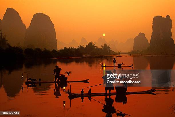 fishing boats on river at sunrise - guilin stock pictures, royalty-free photos & images