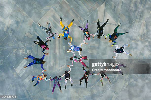 Skydivers forming two circles over earth, view from above