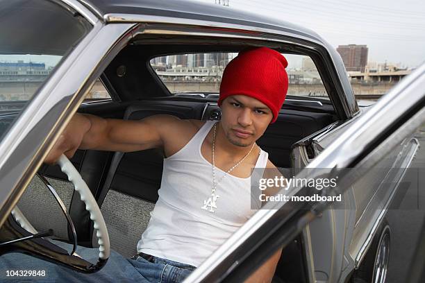 portrait of man sitting in car - low rider stock pictures, royalty-free photos & images