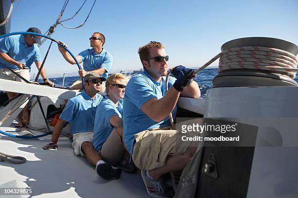 male sailing team on yacht - schiffscrew stock-fotos und bilder