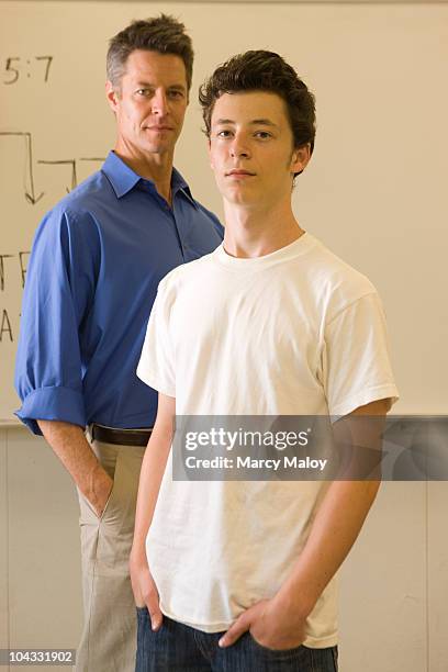 teenage boy and man standing in a classroom. - daly city stock pictures, royalty-free photos & images